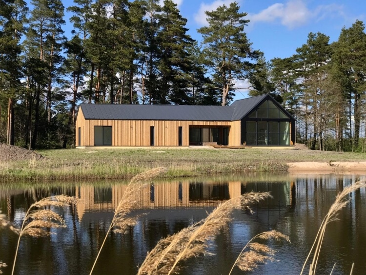 White beach private house with thermo treated pine tree facade and tin roof.